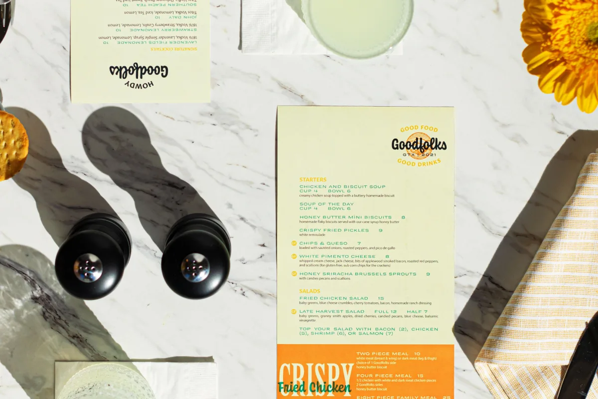 Goodfolks menus on a table from above.