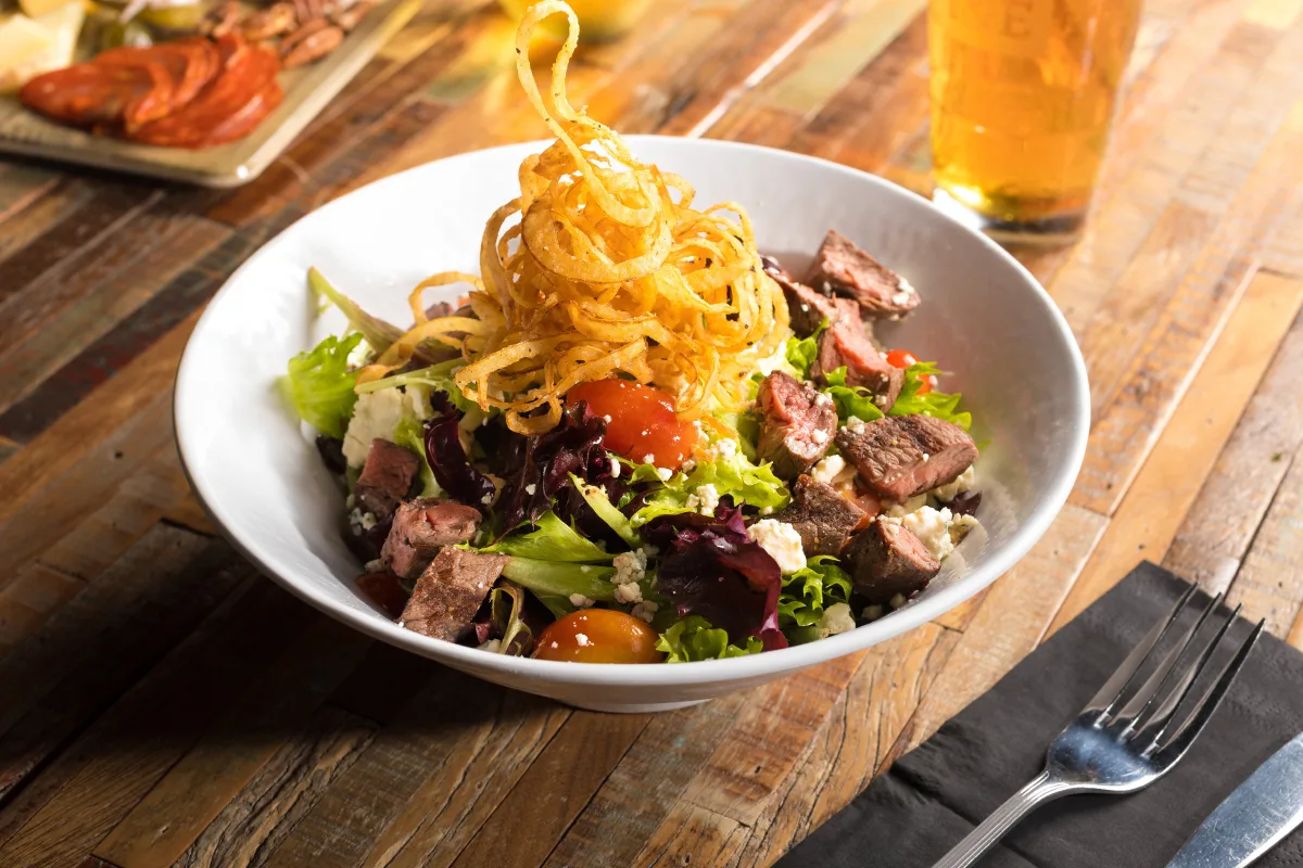Moviehouse & Eatery plated sirloin salad food photography.
